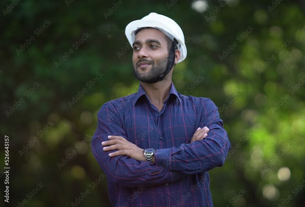 young man engineer was standing and wearing white safety helmet young man engineer was standing and wearing white safety helmet