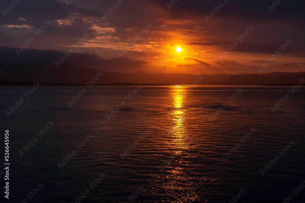 Fototapeta premium Amazing sunset on the Atlantic Ocean. The sun reflected in the waves