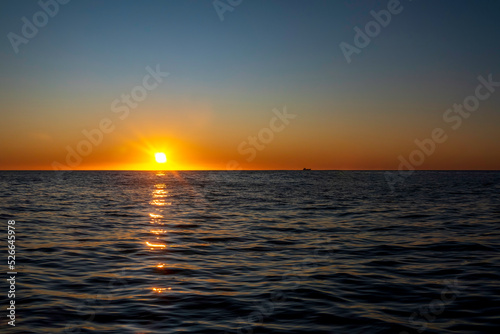 Amazing sunset on the Atlantic Ocean. The sun reflected in the waves © Emma