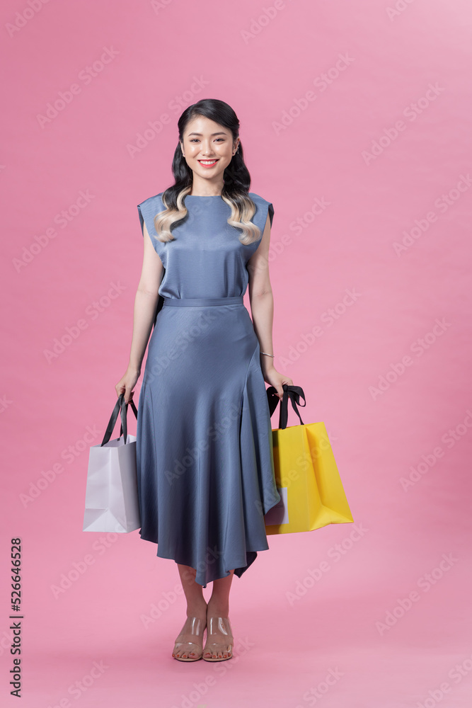 Photo of pretty positive person arms hold bags have good mood isolated on pink color background Photo of pretty positive person arms hold bags have good mood isolated on pink color background