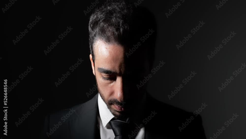 Young Arabian man looking up in dark room. Young Arabian man looking up in dark room.