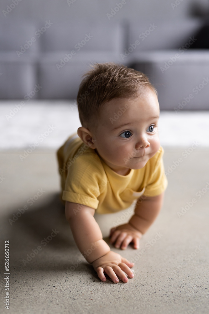 Little pretty baby boy crawling on the floor at home Little pretty baby boy crawling on the floor at home
