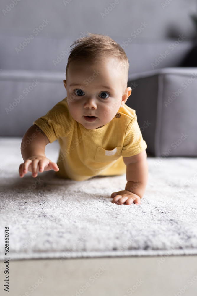 Little pretty baby boy crawling on the floor at home Little pretty baby boy crawling on the floor at home