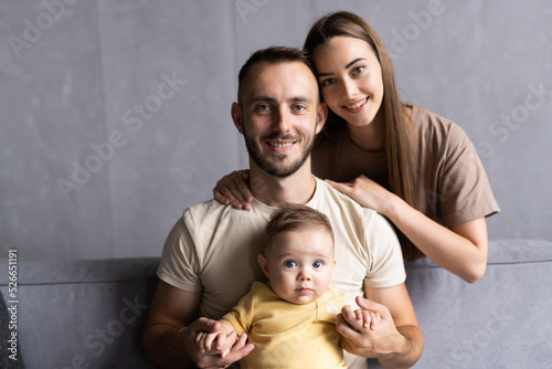 Happy young family on their sofa at home