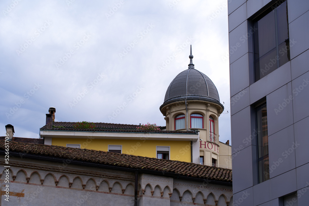 Tower and facades at the old town of Lugano on a cloudy summer day. Photo taken July 4th, 2022, Lugano, Switzerland.