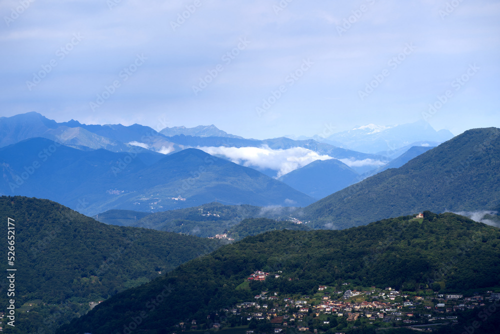 Aerial scenic view over region of Lugano, Canton Ticino, on a cloudy summer day. Photo taken July 4th, 2022, Lugano, Switzerland.