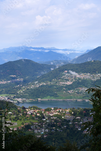 Scenic landscape seen from local mountain San Salvatore, Canton Ticino, over Lake Muzzano on a cloudy summer day. Photo taken July 4th, 2022, Lugano, Switzerland. © Michael Derrer Fuchs