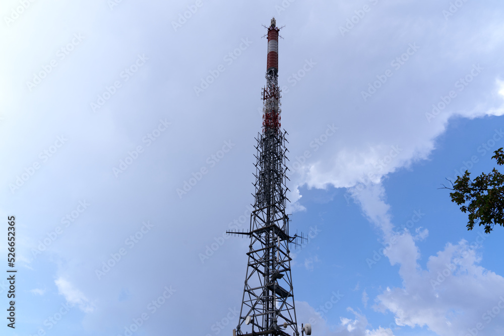 Communications tower at local mountain San Salvatore at City of Lugano on a cloudy summer day. Photo taken July 4th, 2022, Lugano, Switzerland.