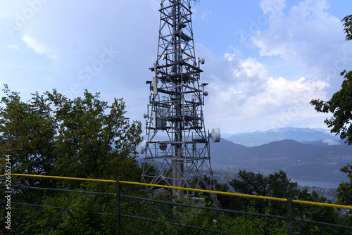 Communications tower at local mountain San Salvatore at City of Lugano on a cloudy summer day. Photo taken July 4th, 2022, Lugano, Switzerland.