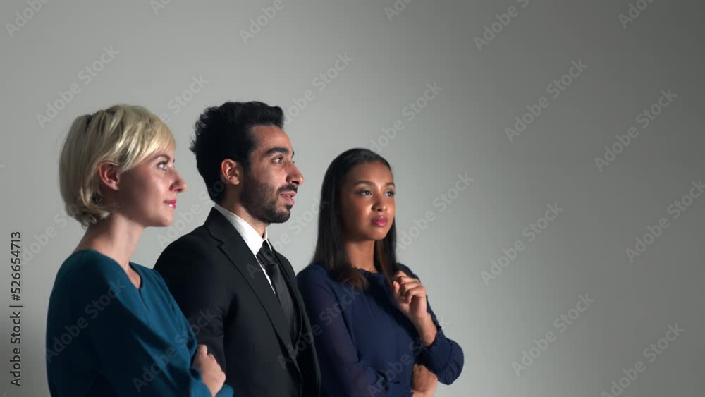 Group of multi national people looking screen in dark room. Group of multi national people looking screen in dark room.