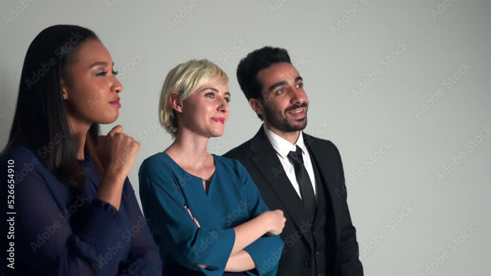 Group of multi national people looking screen in dark room. Group of multi national people looking screen in dark room.