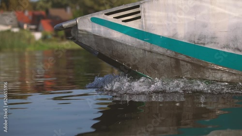 front of boat in water with bow wave in slow motion photo