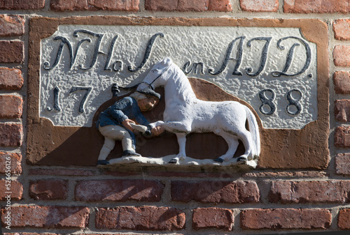 Relief mit Darstellung eines Pferdes an einem Haus in Greetsiel (Nordsee) photo