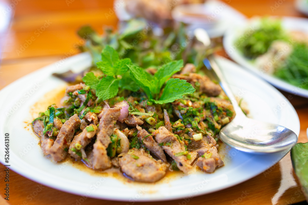 Spicy slide grilled pork salad (with green vegetables and chillies, Thai food.)