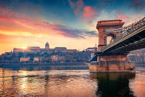 First sunlight glowing Budapest town, capital of Hungary, Europe. Amazing summer view of ChainBridge on Danube river. Traveling concept background.