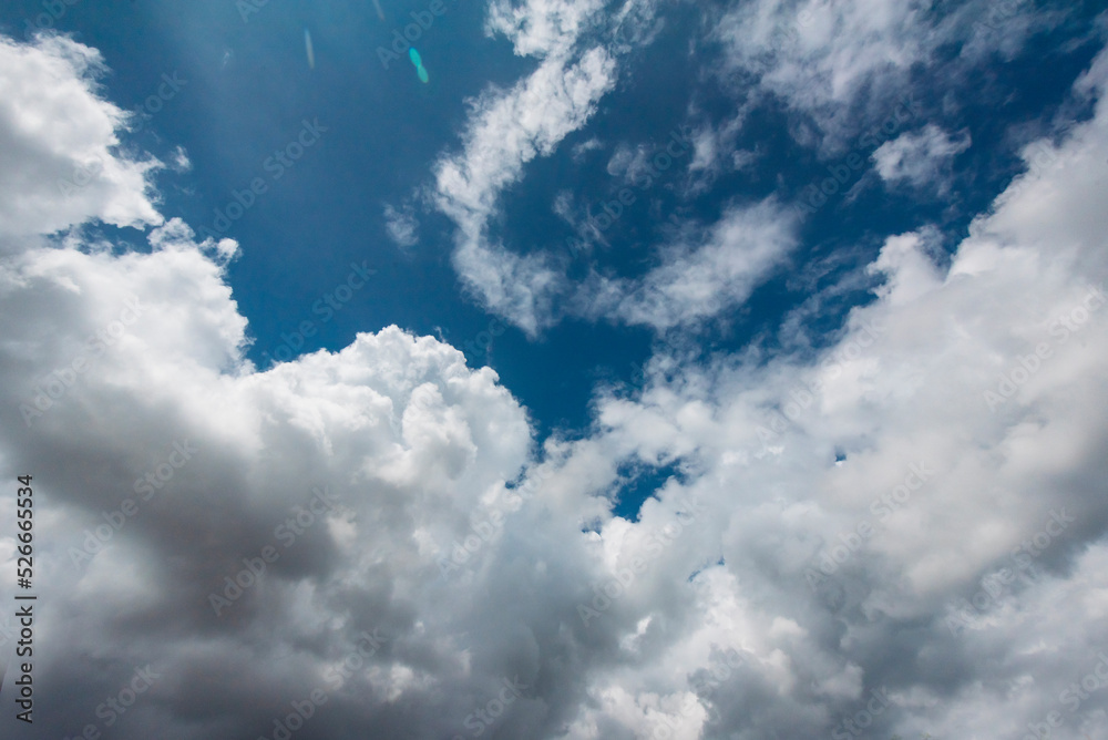 Obraz premium Blue sky fluffy white clouds on summer season bright clear skyline with beautiful cloudscape. Panorama blue sky clouds pattern on daylight with copy space. Cumulus cloudscape air climate sunny day