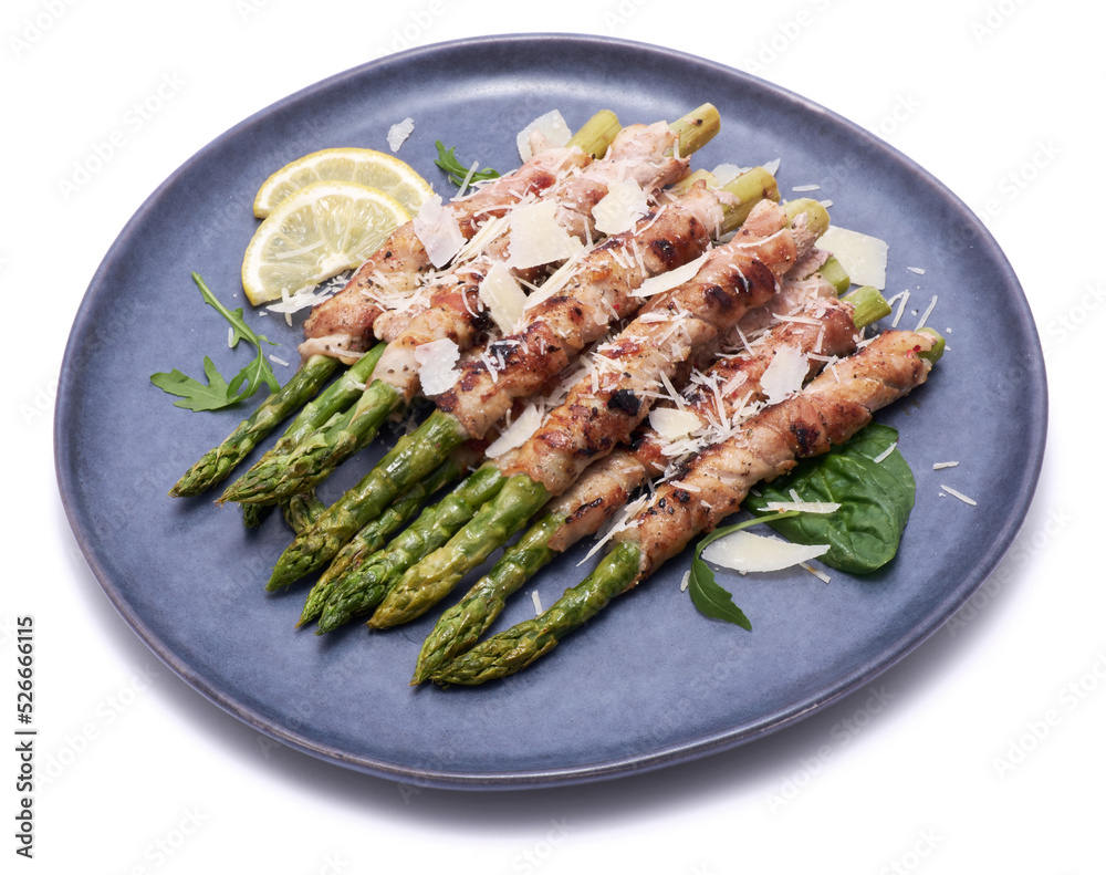 Healthy food - Asparagus wrapped with bacon and spices on a plate isolated on white background Healthy food - Asparagus wrapped with bacon and spices on a plate isolated on white background