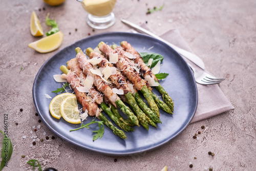 Healthy food - Asparagus wrapped with bacon and spices on a plate