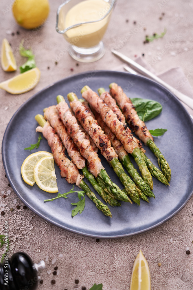 Healthy food - Asparagus wrapped with bacon and spices on a plate Healthy food - Asparagus wrapped with bacon and spices on a plate