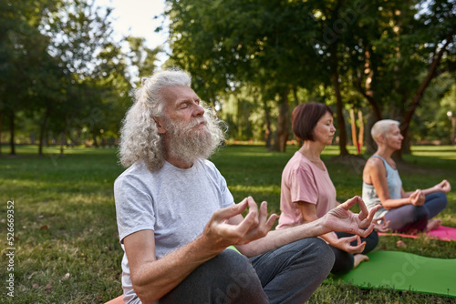 Man with blur friends meditate and practice yoga
