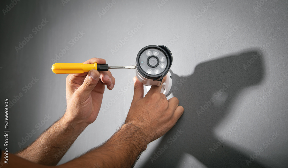 Technician installing CCTV camera system for home. Technician installing CCTV camera system for home.