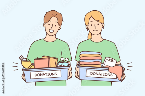 Happy volunteers with donation boxes 