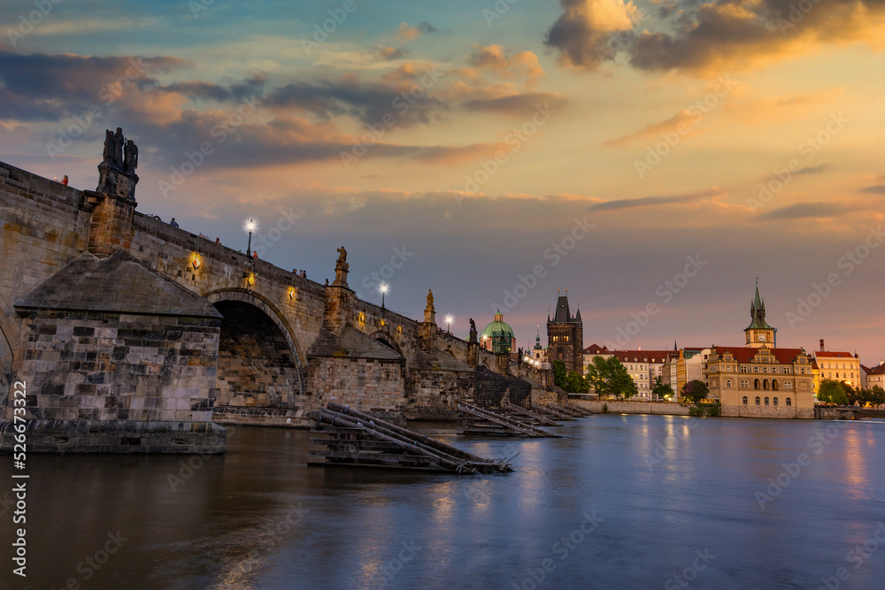 Colorful sunset view on old town, Charles bridge (Karluv Most - in czech) and Vltava river, Prague, Czech Republic.