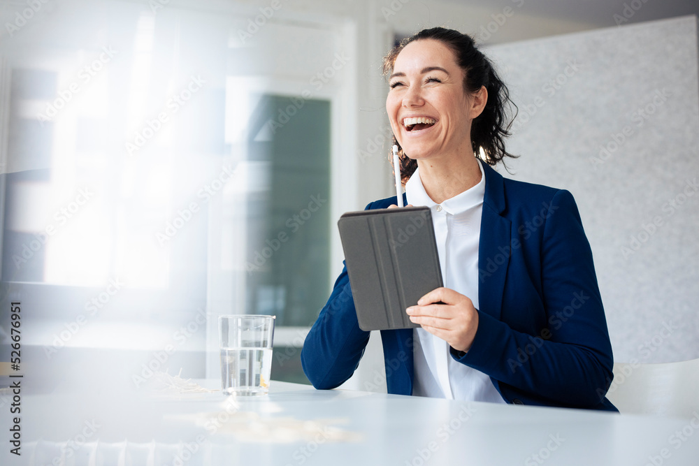Happy businesswoman holding tablet PC and digitized pen Happy businesswoman holding tablet PC and digitized pen