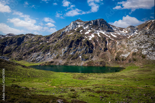 Panoramic view of Lake Cerveriz, in the Somiedo Natural Park, in Asturias, Spain. snow on the peaks, transparent waters photo