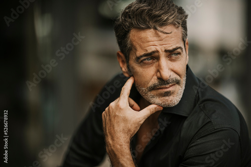 Thoughtful handsome man wearing black shirt