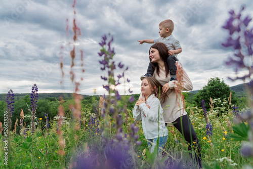 Mother and children in flowery meadow photo