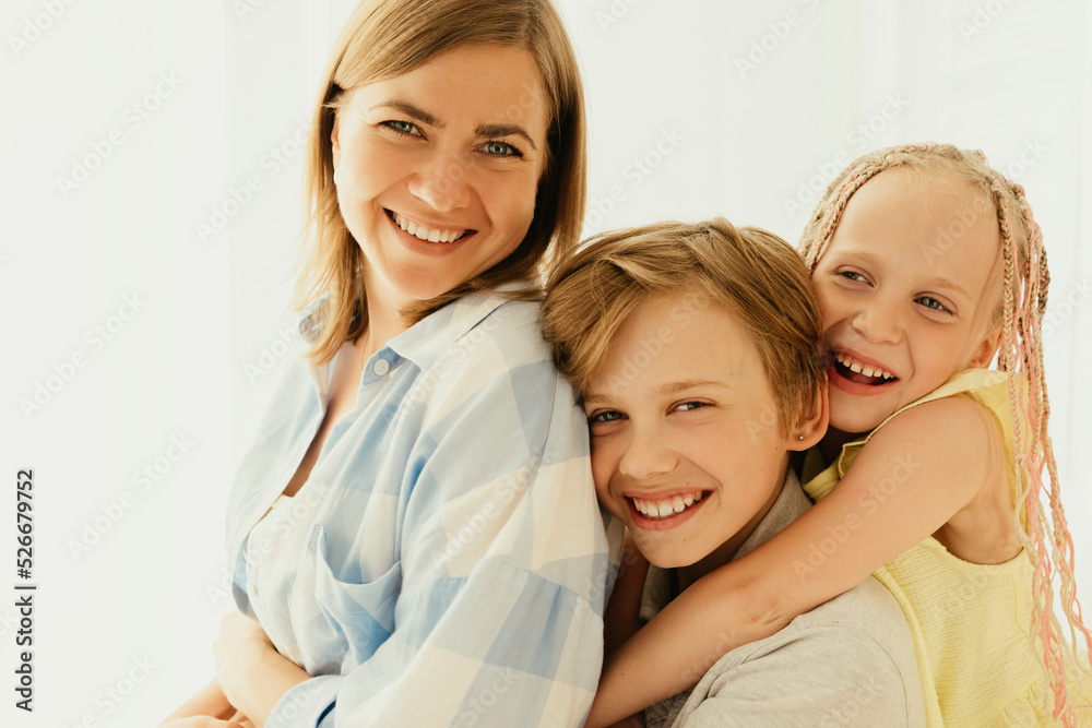 Happy mother with son and daughter spending time together at home Happy mother with son and daughter spending time together at home