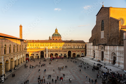 Italy, Emilia-Romagna, Bologna, Piazza Maggiore with Basilica of San Petronio and facade of Palazzo dei Banchi at dusk photo