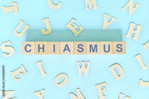 Chiasmus figure of speech concept in English grammar class lesson. Wooden blocks typography flat lay in blue background.	