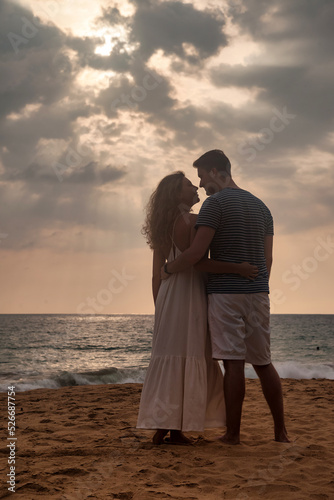 Silhouette happy couple together on tropical sandy beach at sea sunset background. French couple enjoying summer at ocean coastline. Lovely man and woman looking happiness. Copy text space