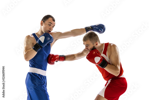 Sportive men  two professional boxer in sports uniform practicing punch isolated on white background. Concept of sport  competition  training  energy