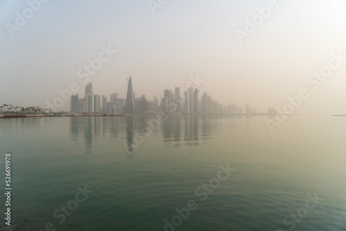 Doha skyline at sunrise with morning fog