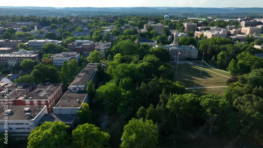 Penn State university college campus. American and PA flags fly at Old Main. Aerial truck shot. Penn State university college campus. American and PA flags fly at Old Main. Aerial truck shot.