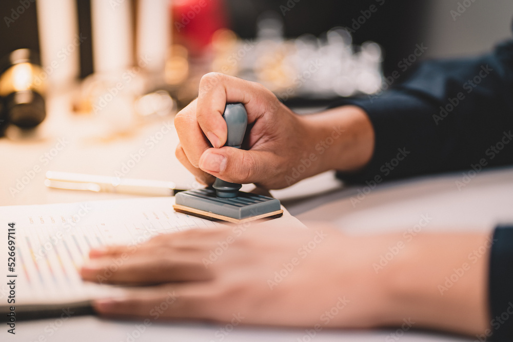 Fototapeta premium Businessman making agreement at office. it's a contract paper. Human hand holding pen mystery document on the table. It's a big decisions for business corporate.