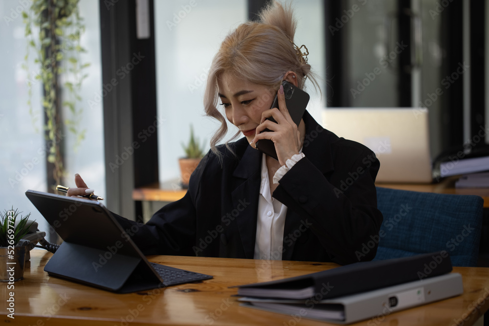 Businesswoman working with calculator and laptop computer at office workplace, finance marketing chart, Business digital technology and marketing concept. Businesswoman working with calculator and laptop computer at office workplace, finance marketing chart, Business digital technology and marketing concept.