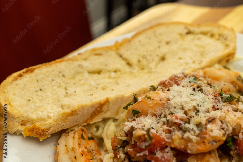 Shrimp Fra Diavolo Topped with Shaved Asiago Cheese served with  a slice of Asiago Cheese Bread 