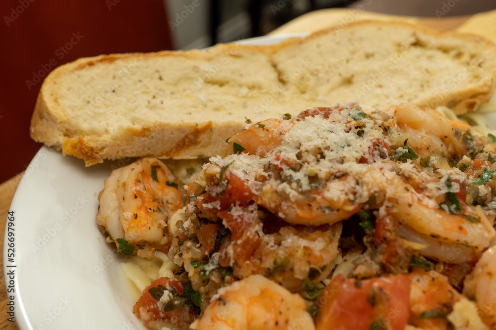 Shrimp Fra Diavolo Topped with Shaved Asiago Cheese served with  a slice of Asiago Cheese Bread 