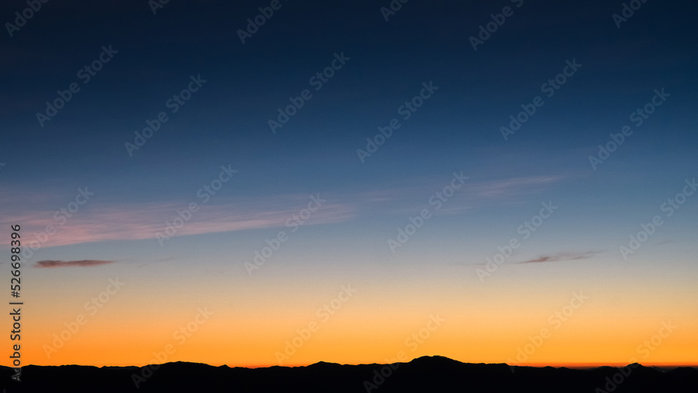 Beautiful bright cloud sky with light for heaven religion background. Sunrise and twilight or sunset cloudscape is orange and blue colours in summer nature. Beautiful bright cloud sky with light for heaven religion background. Sunrise and twilight or sunset cloudscape is orange and blue colours in summer nature.