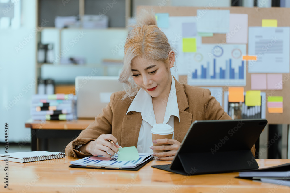 Businesswoman working with calculator and laptop computer at office workplace, finance marketing chart, Business digital technology and marketing concept. Businesswoman working with calculator and laptop computer at office workplace, finance marketing chart, Business digital technology and marketing concept.