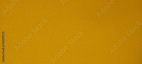 Abstract faded backdrop effect metallic gold yellow and orange blank shiny paper background texture with copy space. Reflective surface colorful design for commercial advertisement and business use.