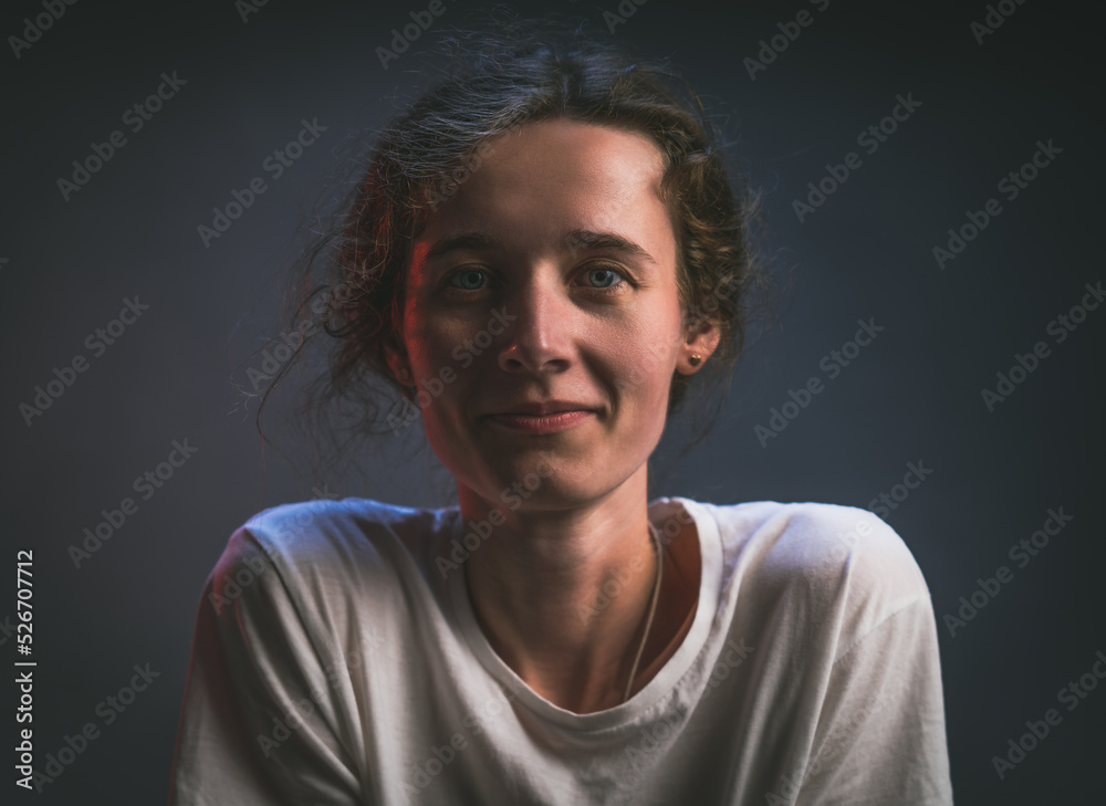 Young thin girl like a boy in a white t-shirt look straight smiling portrait on a gray background baby face girl looks like a boy tanned face Young thin girl like a boy in a white t-shirt look straight smiling portrait on a gray background baby face girl looks like a boy tanned face