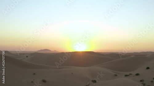 Sand dune sunrise panning into grand open sun rays. Aerial drone footage of sandy desert hills. Shot on DJI Mavic 2 Pro. Imperial Sand Dunes, California United States photo