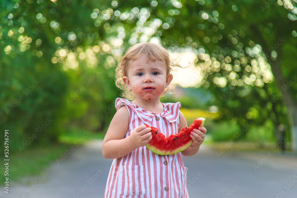 Child girl eats watermelon in summer. Selective focus. Child girl eats watermelon in summer. Selective focus.