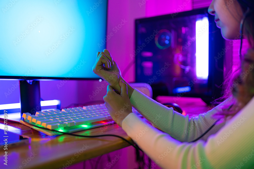 Wrist pain concept. Gamer and ESport online of Asian woman playing