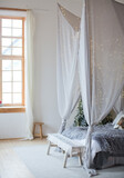 Christmas scandinavian bedroom with white canopy